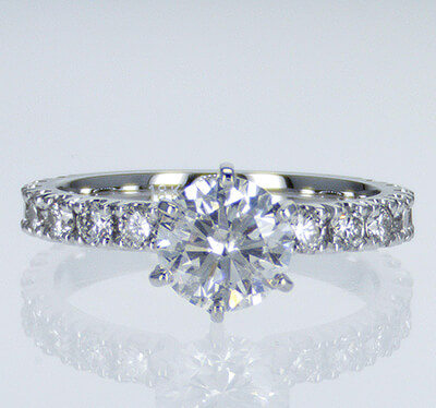 Engagement ring side set with round diamonds